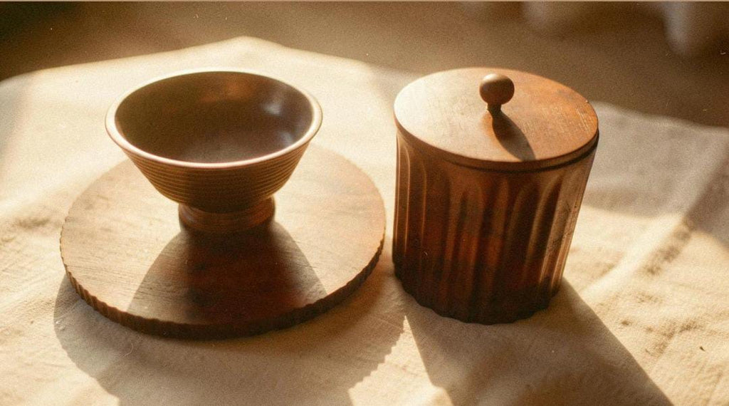 Wooden serving setup with a round wooden board, pedestal bowl and lidded wooden ice bucket