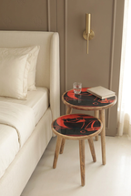 Orange Horse printed wooden nesting side tables, set of two, styled beside a bed in a luxury bedroom