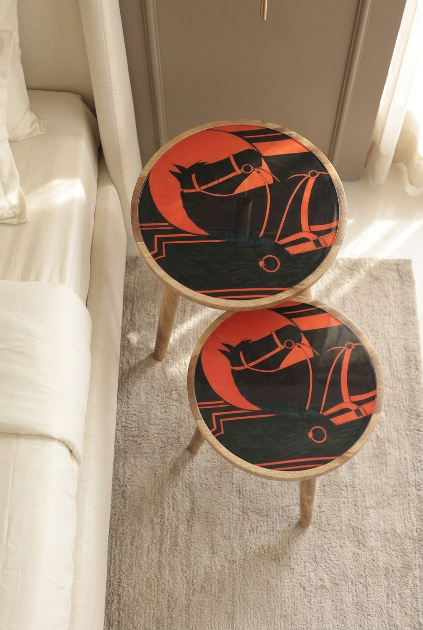 Top view of Orange Horse printed wooden nesting side tables, set of two, beside a bed in a luxury bedroom